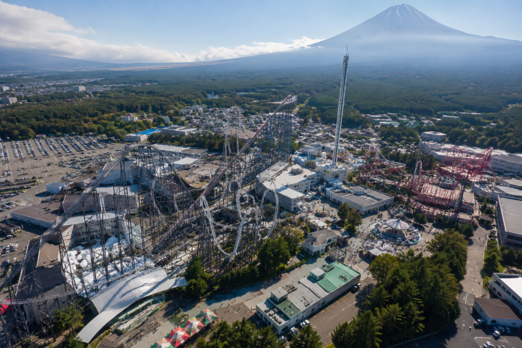 Aerial view of Fuji-Q Highland amusement park with Mount Fuji in the background near Lake Kawaguchi