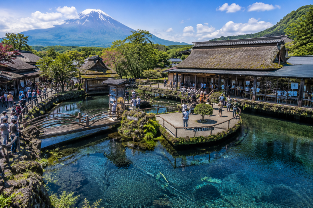 Visitors enjoying Oshino Hakkai, a famous sightseeing spot near Lake Kawaguchi with clear spring water ponds and views of Mount Fuji