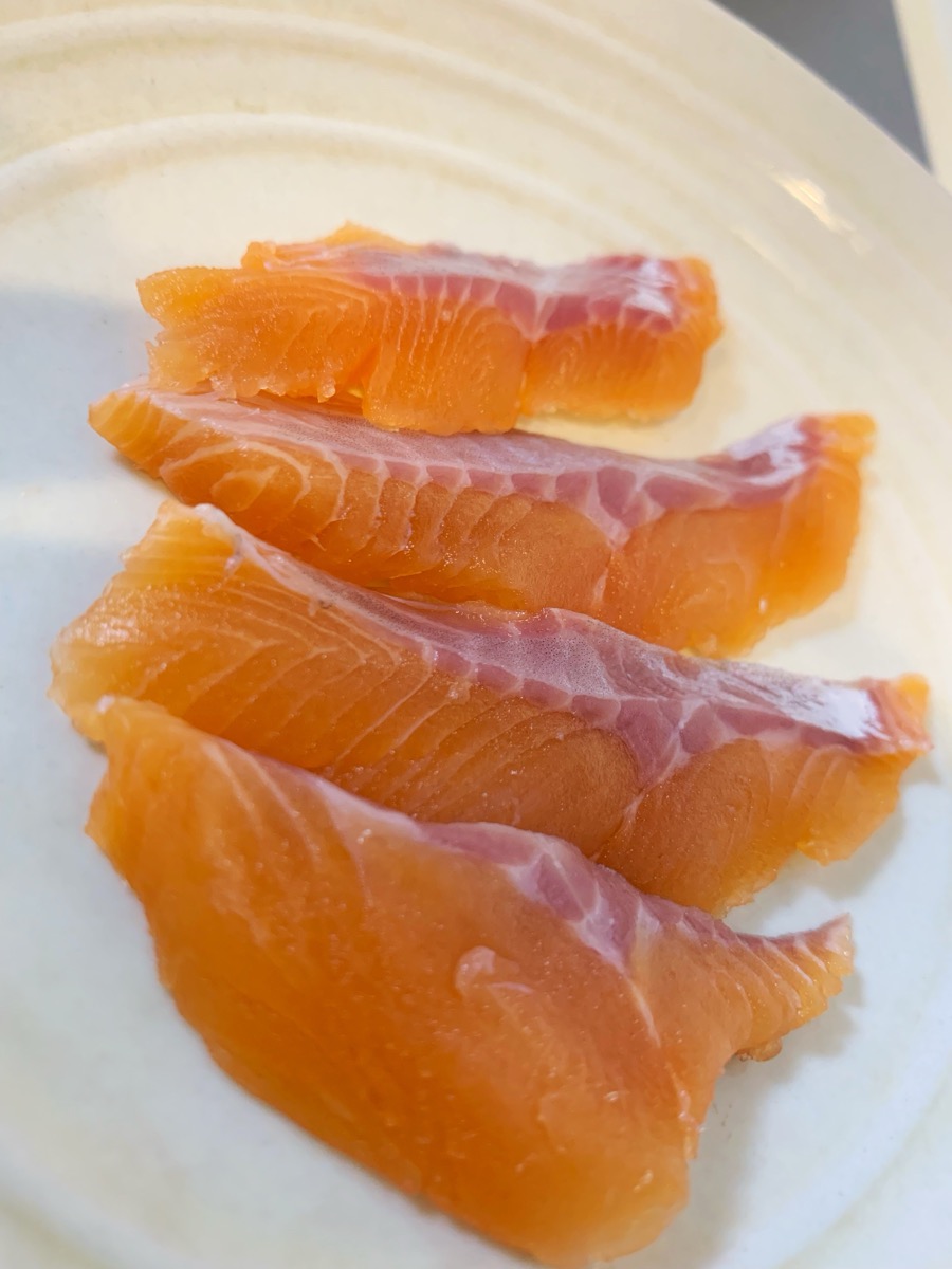 Vivid pink Biwa trout fillets on a plate