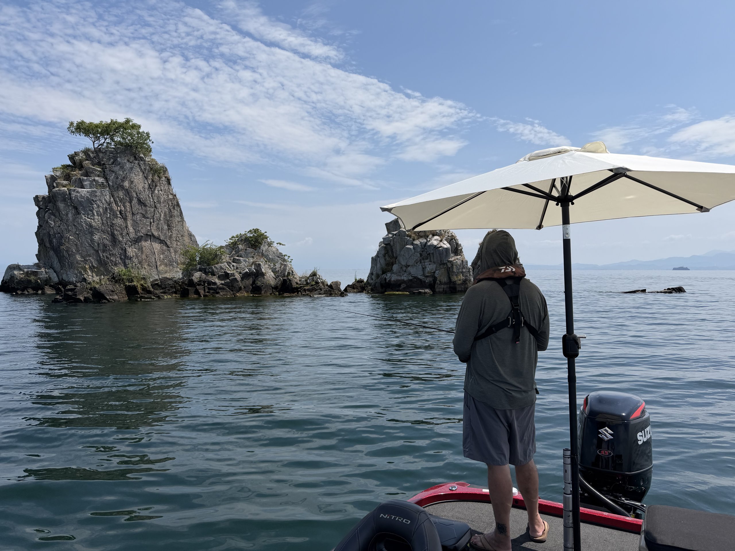 Bass boat with a sun umbrella near Chikubushima island on Lake Biwa